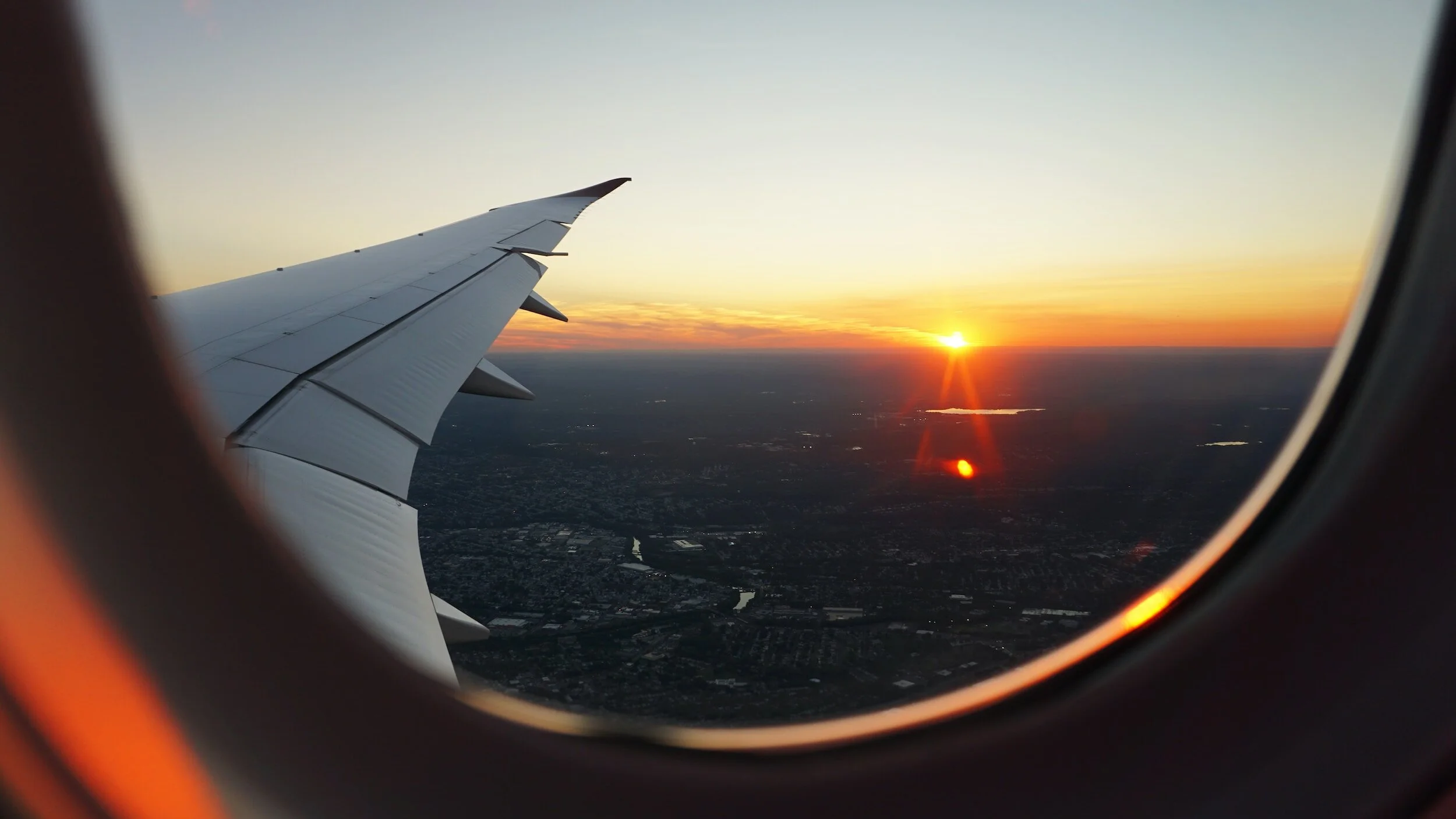 Sunset view out of plane window while landing