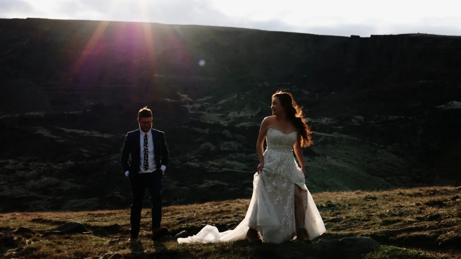 Bride and groom walk under midnight sun Iceland elopement