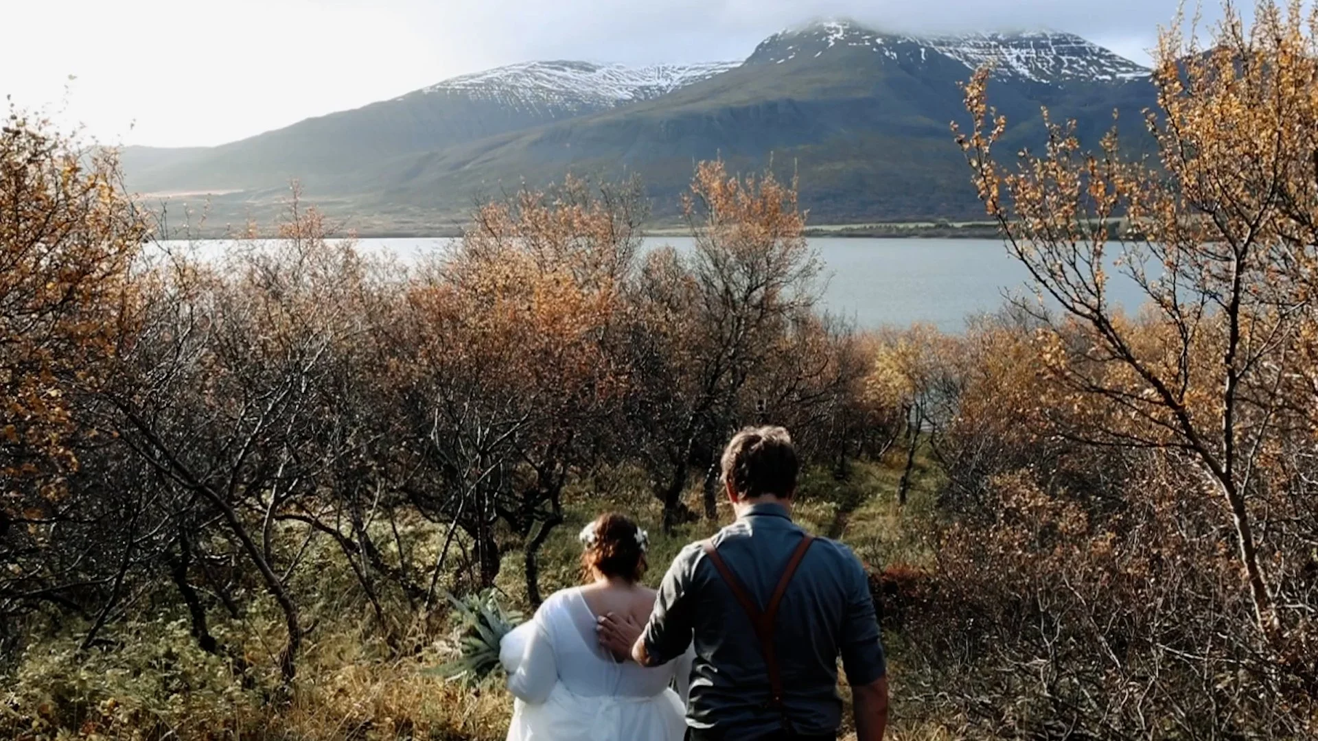 Iceland elopement couple walk to lake for wedding ceremony