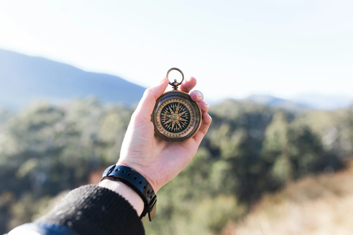 Hand holding compass in Iceland elopement planning