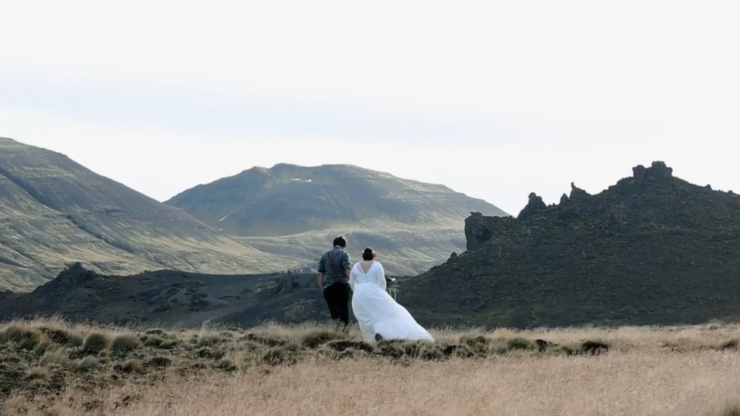 Iceland elopement couple walk towards jagged ridge