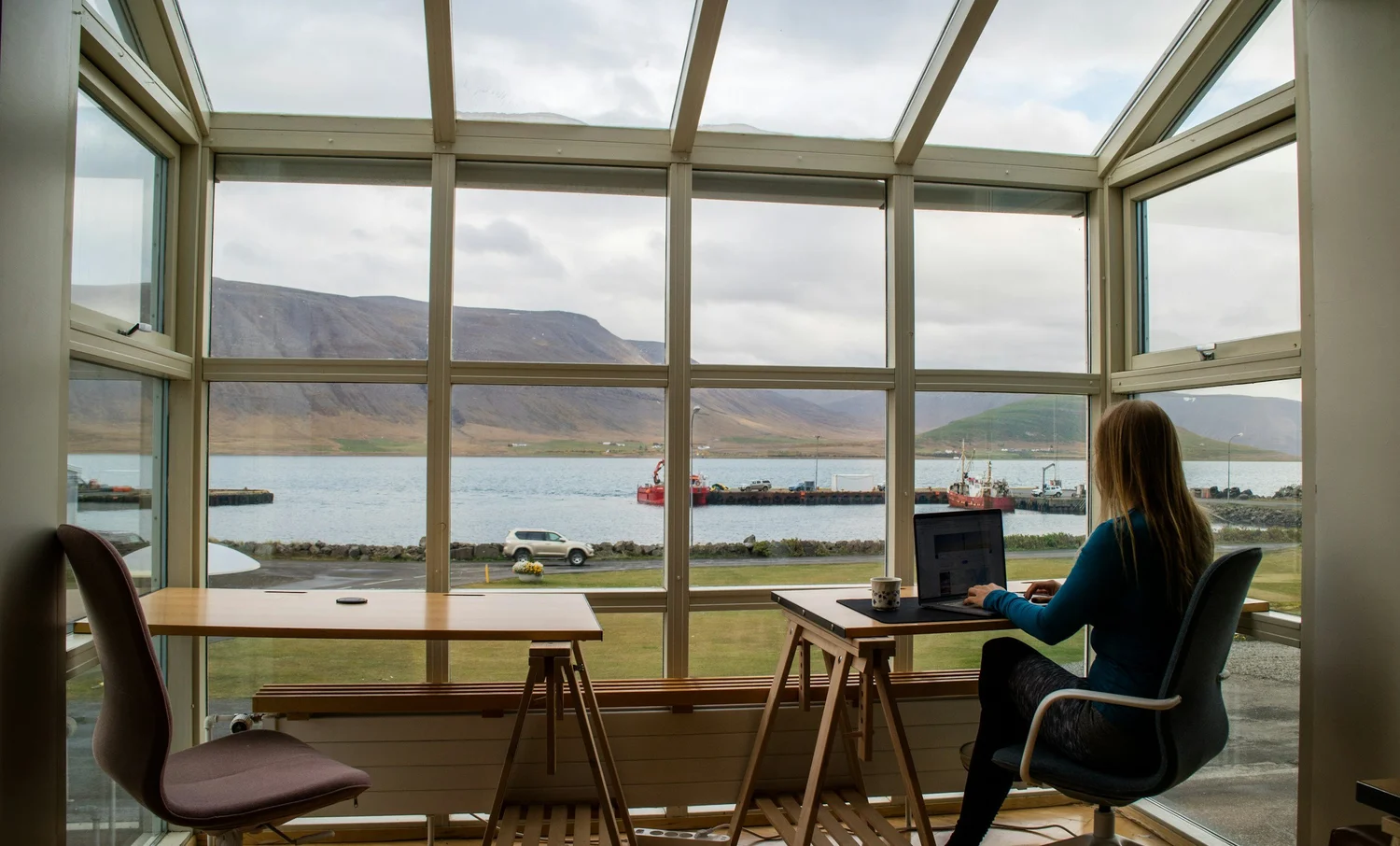 Iceland videographer sits in cafe glasshouse