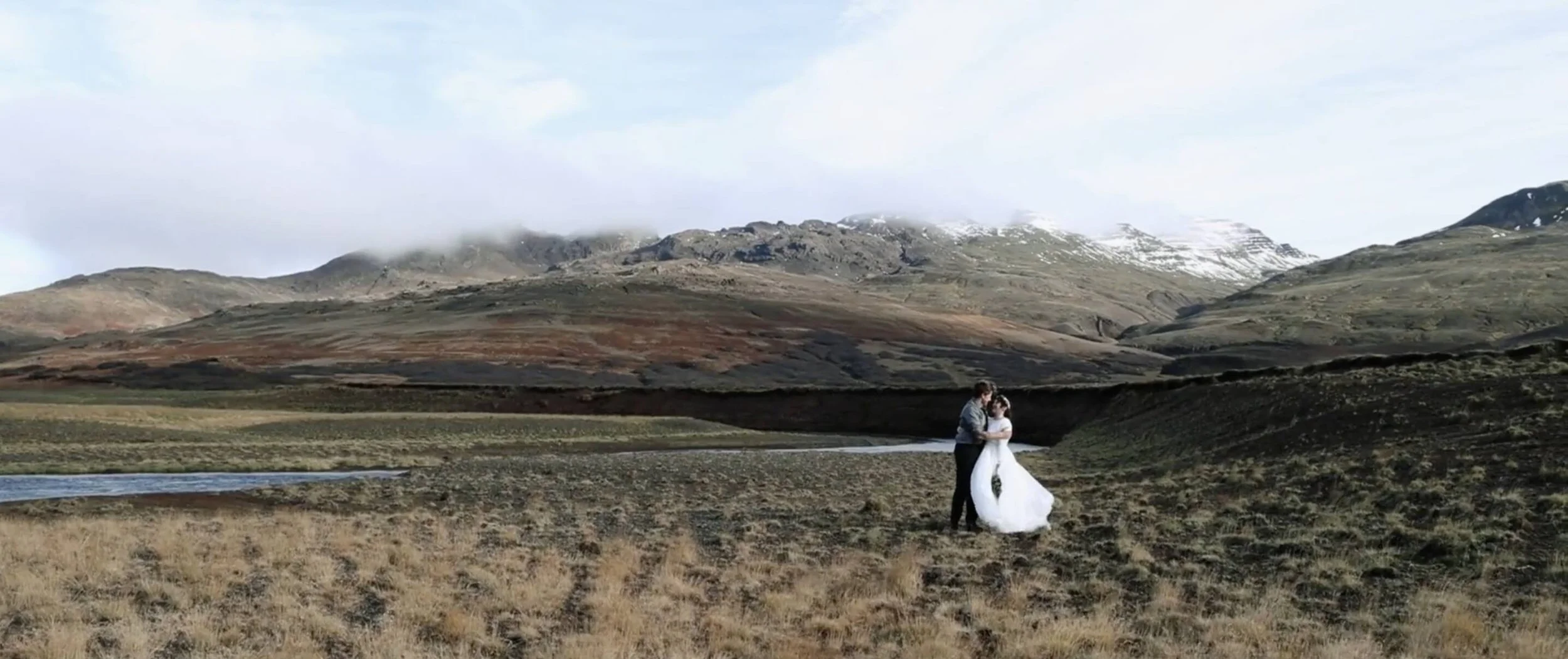 iceland elopement couple kiss in front of mountains